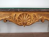 an image of a gold console table with a green marble top
