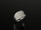 a white gold and diamond ring on a black surface