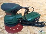 a green and black sander and a red and black sander
