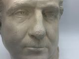 a white bust of a man with a crown on his head