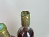 two bottles of wine sitting next to each other on a table