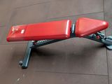a red bench sitting on the floor in the room