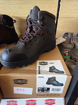 many pairs of shoes that are on top of a box