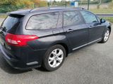 a black car that is parked on the side of the road