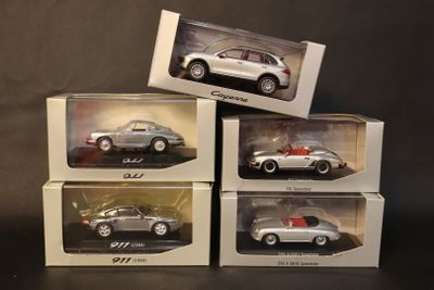 four different models of cars in boxes on a black surface