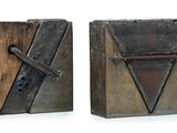 these are two bookends made of metal and wood with a cross on the front
