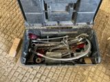 many tools in a tool box on the ground