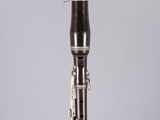 a close up of a bassoon on a clear acrylic stand