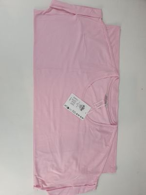 a pink shirt with a tag on it sitting on top of a table