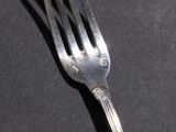 a fork that is sitting on a black table