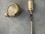 a silver object on the floor next to a baseball bat
