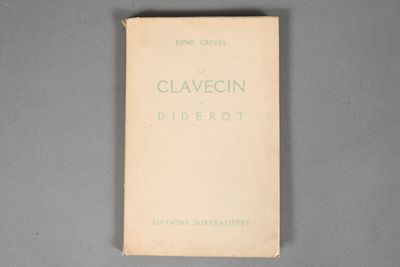 an old book sitting on top of a table next to a gray table