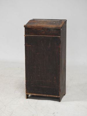 an old wooden cabinet with a door and a drawer on top of it