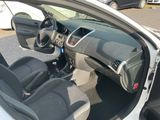 the interior of a car with the door open and the driver ' s seat down