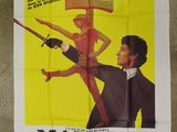an old movie poster of a man holding a knife and a gun