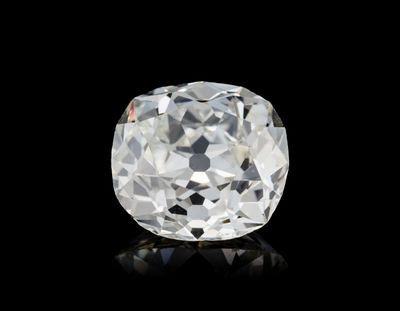 a close up of a white diamond on a black surface