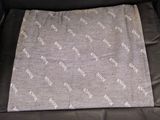 the back of a car seat with a blanket on top of it