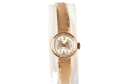 an image of a woman ' s wrist watch with a gold band