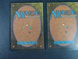 two decks of magic the gathering deck cards on a table