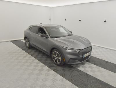a grey 2020 ford mustang macht is parked in a garage