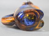 a glass animal that is laying down on a table