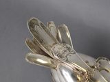 a silver spoon and fork on a white plate