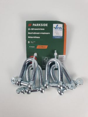 three pieces of metal hooks are on a white surface