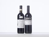 two bottles of red wine sitting next to each other on a table