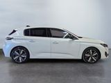 the white car is parked in a large room with a white wall