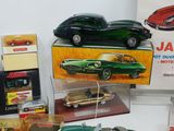 several toy cars are on display in a display case on a table