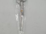 a pair of scissors in a plastic bag on a table