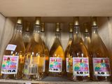 several bottles of wine sit on a shelf in a store