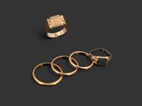 three gold rings and a gold ring on a black background