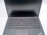 a black laptop with a red button on the keyboard