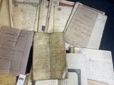 a pile of old papers sitting on top of a table