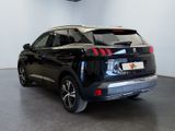 the rear end of a black car in a showroom