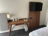 a small desk with a television on top of it