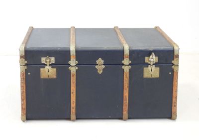 a black trunk with two gold handles and a black top