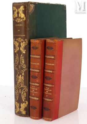 three books are stacked on top of each other on a white surface