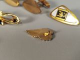 many different types of gold and silver jewelry on a table