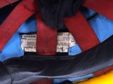 a close up of a helmet with a red and blue cover