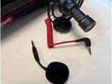 a microphone and headphones on a table next to a bag