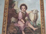 a painting of a young boy with a sheep on the wall