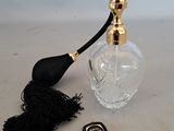 a small bottle of perfume with a tassel on the table