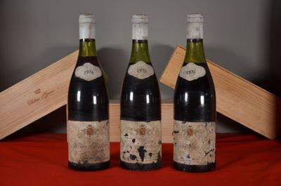 three bottles of wine sitting on a table next to a wooden box