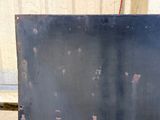 a black piece of metal with holes on it