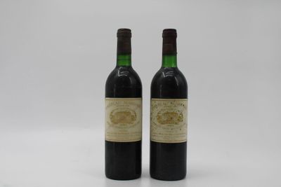 two bottles of wine sitting next to each other on a white surface