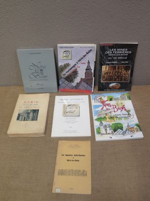 several books are sitting on a table in front of a wall
