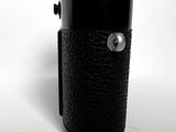 a black leather case with a button on it