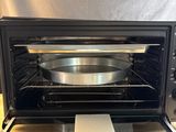 an open oven with a pan in it on a counter
